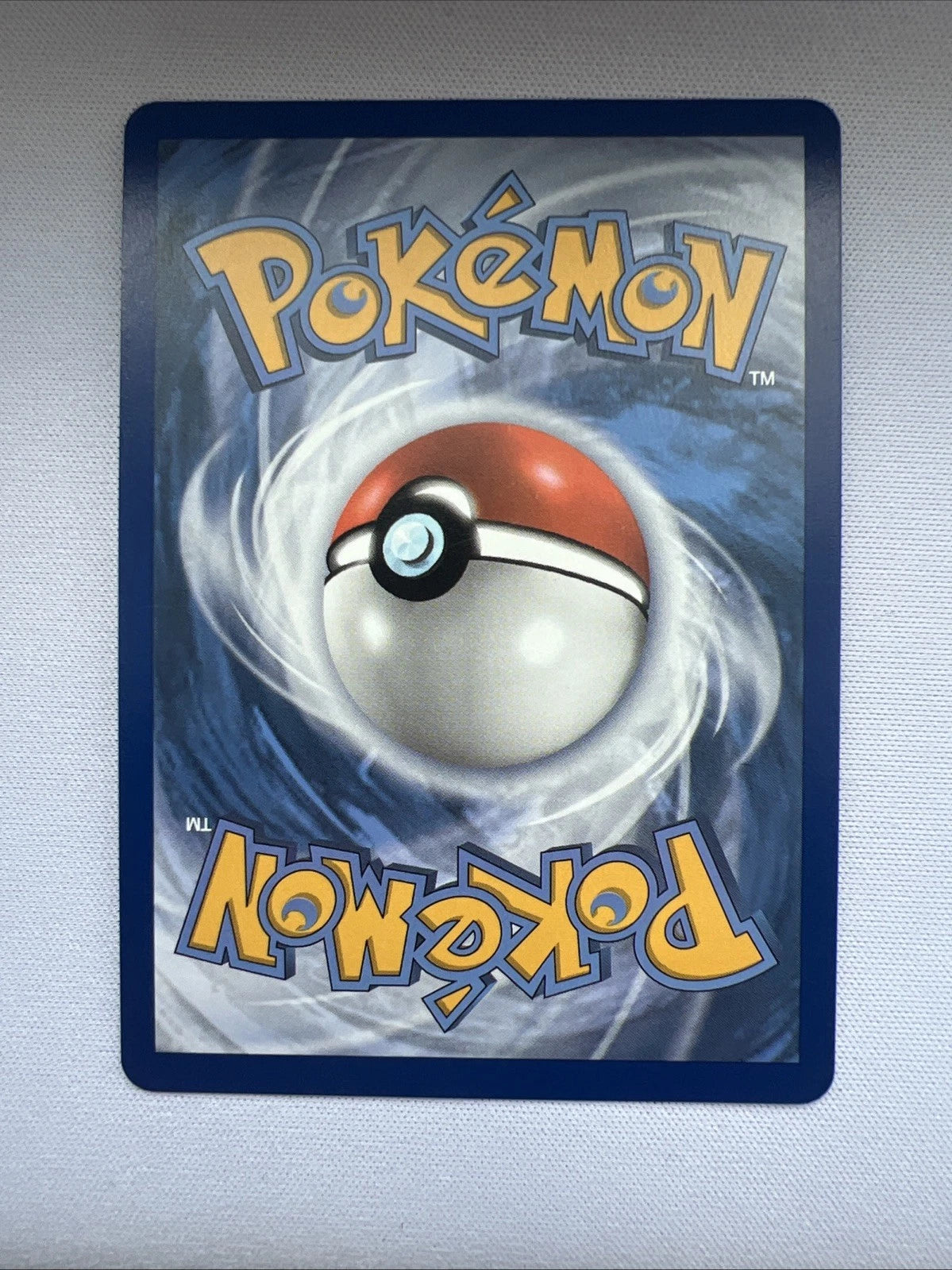 Blastoise V Promo SWSH101 with Pokémon trading card with Poké Ball design on a gray background