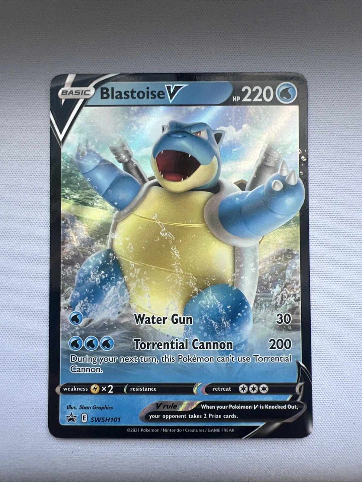 Pokémon trading card featuring Blastoise V promo from sword and shield era (SWSH101) on a gray background