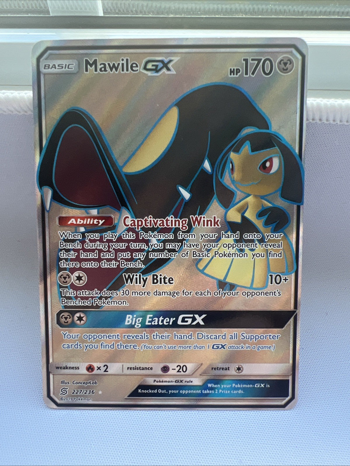Pokémon trading card featuring Mawile GX on a light blue background