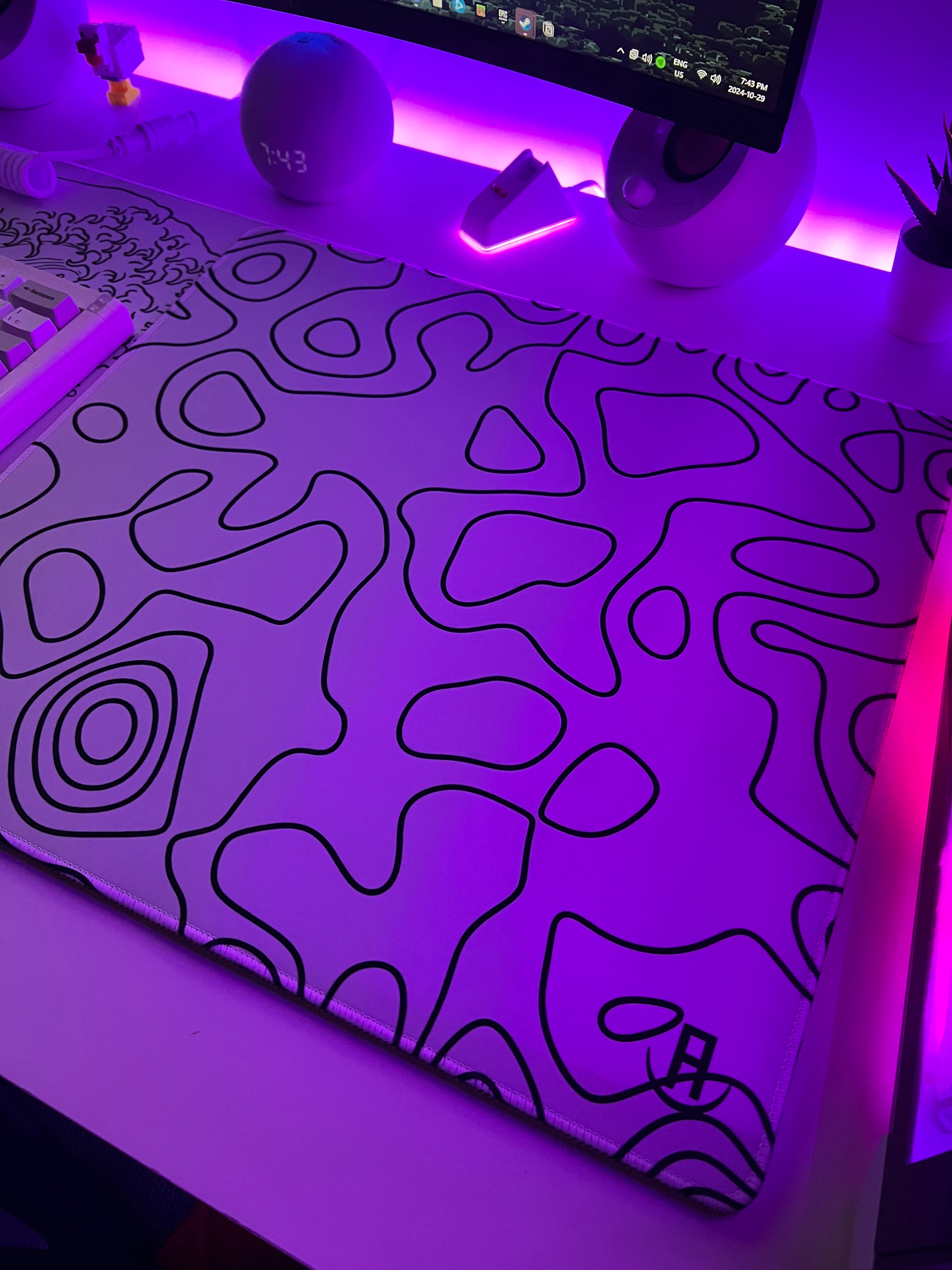 white topography mousepad in gaming setup on white desk